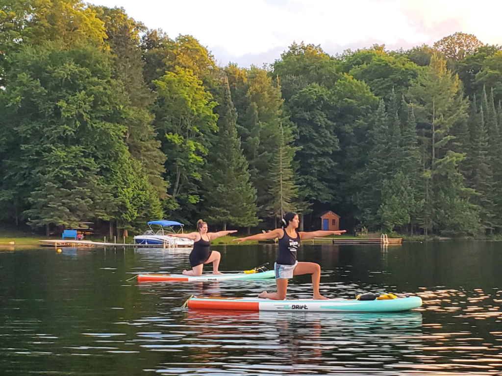 SUP Yoga. Stand up paddle boarding on the lake