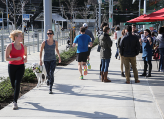 Dan Burden, Blue Zones Fellow, takes an image of pedestrians in a walkable city in the U.S.