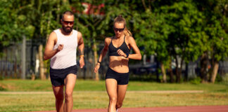 Woman and man jogging in the stadium