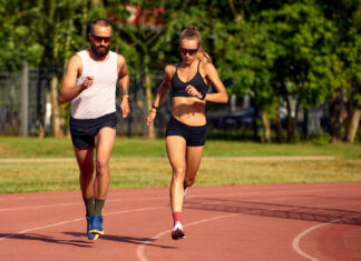 Woman and man jogging in the stadium